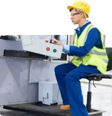 Cnc machinist controlling a wood cutting machine