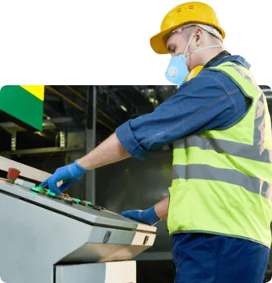 worker operating a machine in high visibility clothing