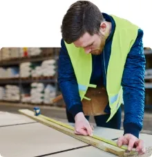 \nTradesman measuring and cutting wood \n