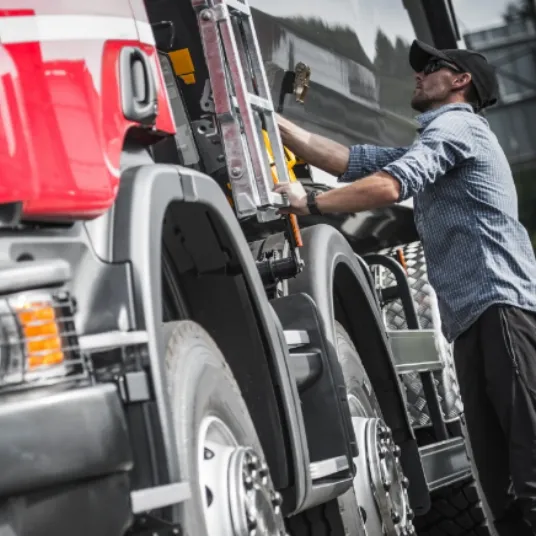 Truck driver getting into a truck\n