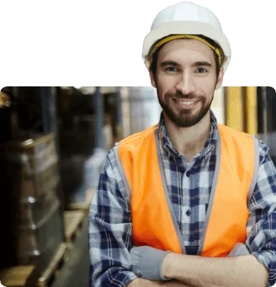looking into the camera wearing a high visibility vest and hard hat